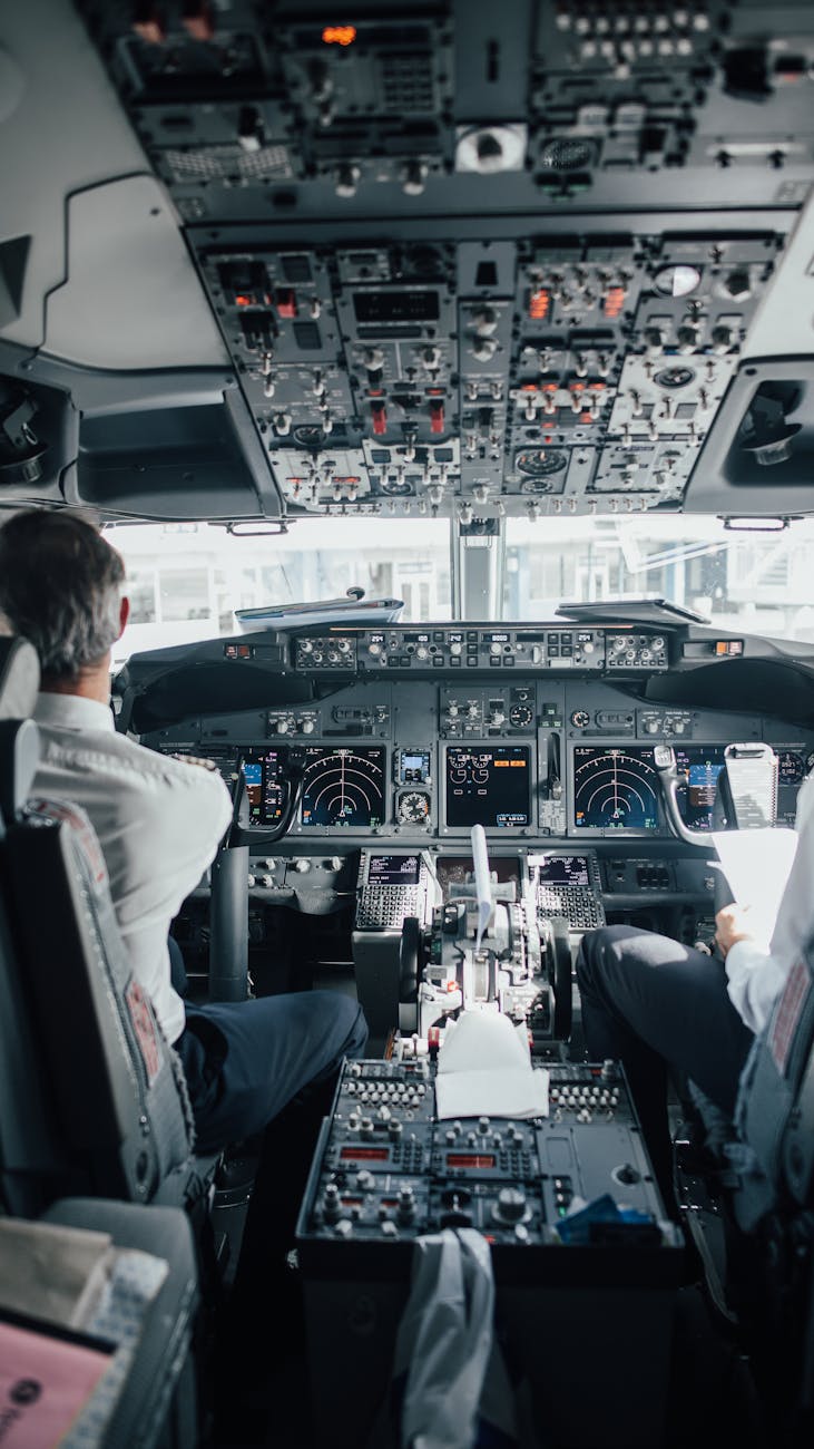man sitting inside a cockpit of an airplane