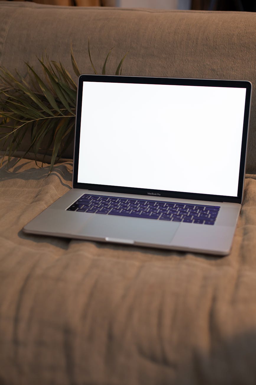 open laptop with mockup blank screen on couch